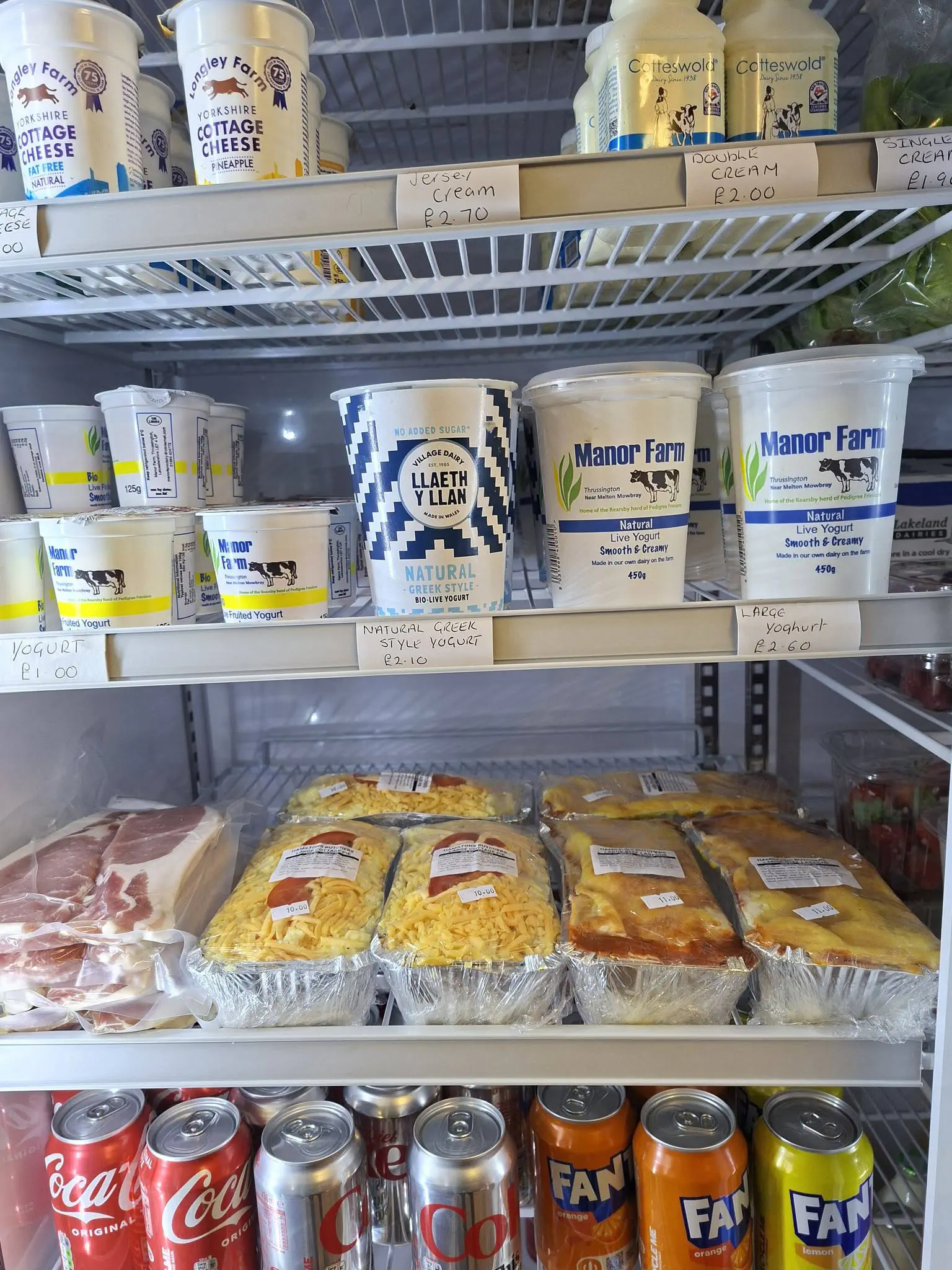 Pots of Manor Farm yogurt in the shop fridge.