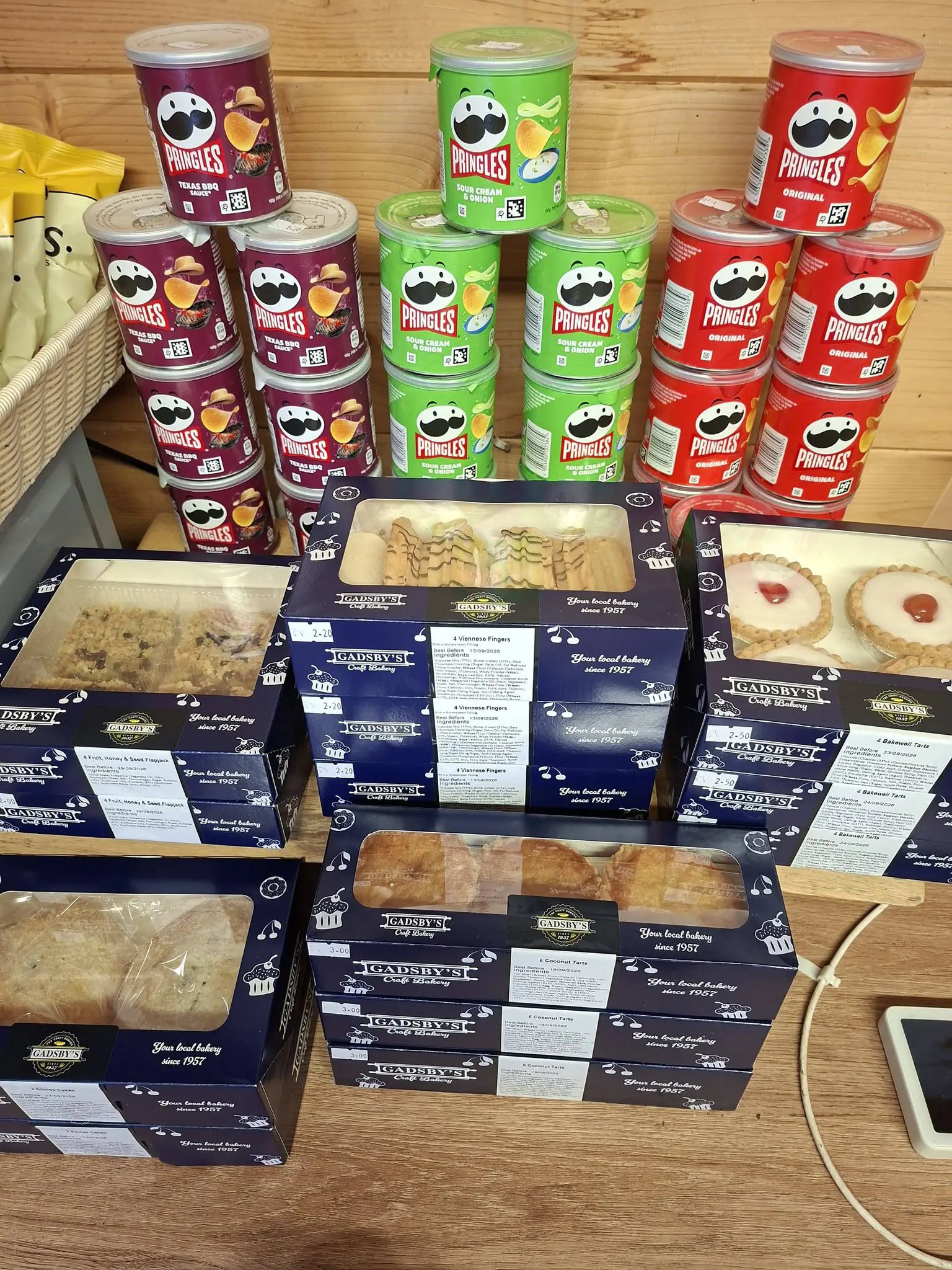 Boxes of Gadsby’s cakes and pastries on the bakery shelf.