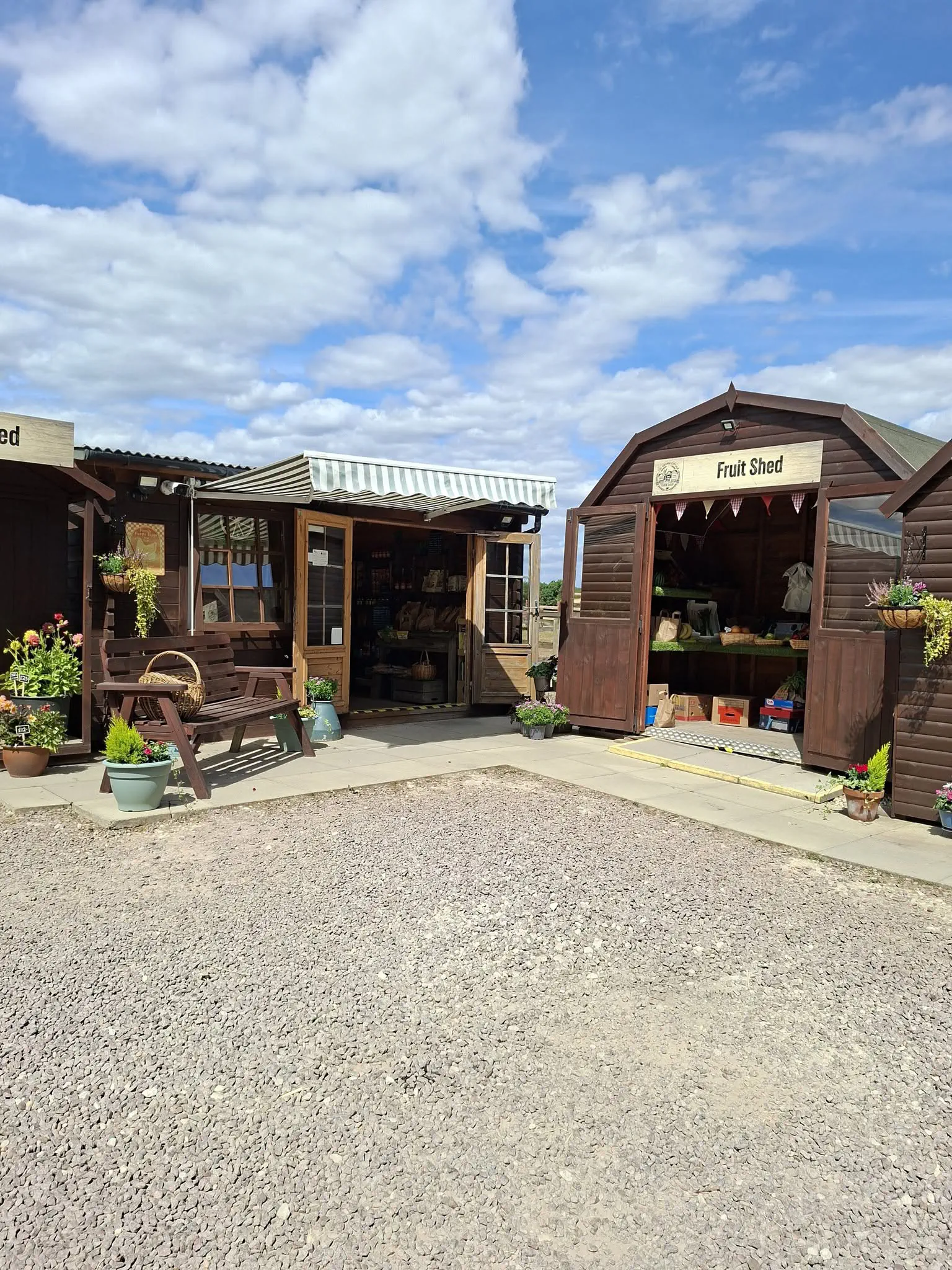 Looking into the shop from the yard, with the fruit shed open beside the door.